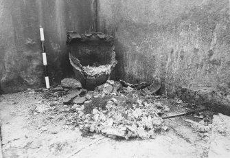 Excavation photographs: Food Vessel Urn in corner of cist; cist after removal of contents.