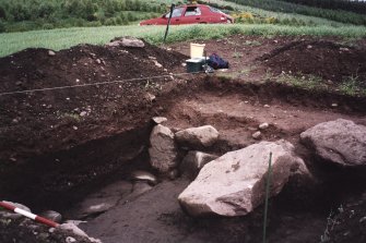 View lokking towards NE corner of the excavation trench. Scale in 200mm divisions