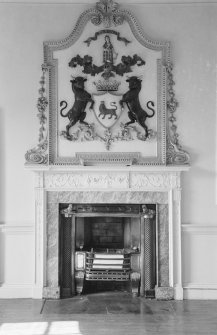 Interior view of Airlie Castle showing detail of fireplace and coat of arms.