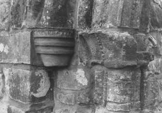 Detail of roundheaded doorway capitals supporting W side of arch.