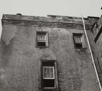 Glasgow, Castlemilk House.
Detail of upper storeys and parapet of Tower House from South-East.
