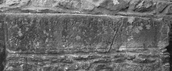 Detail of stone grave slab inset into wall.