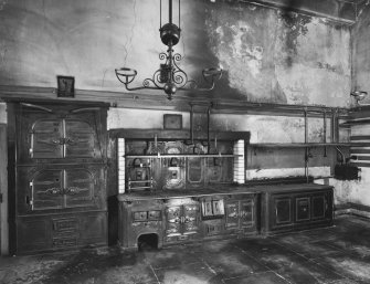 Interior.
View of ovens and range in kitchen showing cast-iron fitments.