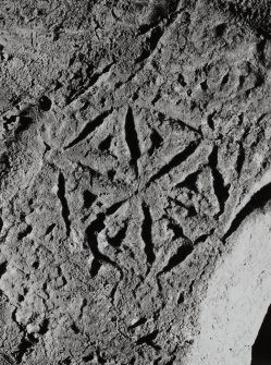 Detail of incised carving over window at E end of S wall.