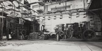 Interior view of East end of ropewalk showing walk machinery; foregear, traveller and top-cart (reading right to left).