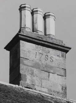 View of chimney stack with incised date.