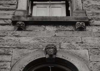 Detail of carved masks on keystones and console brackets