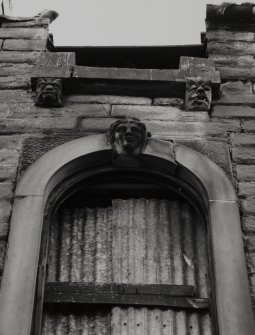 Detail of carved masks on keystones and console brackets