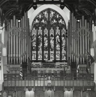 Interior, detail of stained glass window and organ at west end