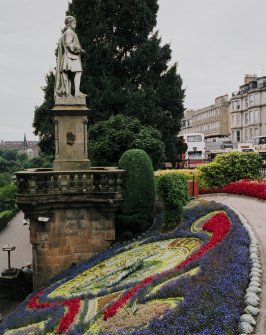 View of floral clock and statue of Alan Ramsay from east