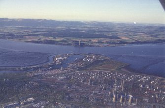 Oblique aerial view centred on the docks and oil refinery, taken from the SSW.