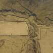 Oblique aerial view centred on the remains of the bastle, farmstead, buchts and sheepfold, taken from the NNW.