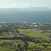 General oblique aerial view of the town and race course with Arran in the background, taken from the SE.