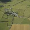 General oblique aerial view of the village with the ramains of the motte adjacent, taken from the ESE.