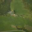 Oblique aerial view centred on the remains of the stone circle and the farmhouse and farmsteading, taken from the SSW.