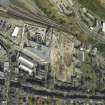 Oblique aerial view centred on the railway goods station and the construction of the car park, taken from the WSW.