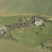 Oblique aerial view centred on the country house, stable block and landscaped gardens, taken from the SW.