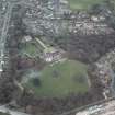 Oblique aerial view centred on the house and walled garden with the gate lodge adjacent, taken from the N.