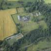 Oblique aerial view centred on the country house, formal garden and stables, taken from the S.