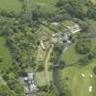 General oblique aerial view of the country house, stables and walled garden, taken from the NW.