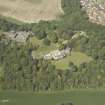 Oblique aerial view centred on the country house and stable block, taken from the S.