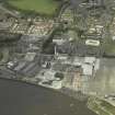 Oblique aerial view.  Alloa Glass Works, gasholder and harbour from S.