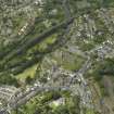 Oblique aerial view of Dunblane centred on the cathedral, chapel, burial-ground and hall with the railway viaduct adjacent, taken from the ESE.