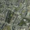 Oblique aerial view centred on the churches, session house, school, museum, art gallery and gardens, taken from the SE.