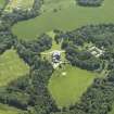 Oblique aerial view centred on the country house, stable block and walled garden, taken from the N.