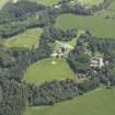 Oblique aerial view centred on the country house, stable block and walled garden, taken from the NNW.