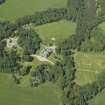 Oblique aerial view centred on the country house, stable block and walled garden, taken from the S.
