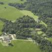 General oblique aerial view centred on the castle, tower-house, walled garden and farmsteading, taken from the SE.