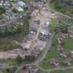 Oblique aerial view centred on the whisky distillery during demolition, taken from the SW.