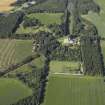 Oblique aerial view centred on the castle, country house and walled garden with the lodge adjacent, taken from the NE.