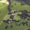 Oblique aerial view centred on the country house, tower-house, farmhouse, farmsteading, cottages and stables, taken from the WSW.