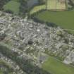 Oblique aerial view of the town centred on the church, school, chapel and parsonage, taken from the S.