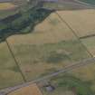Oblique aerial view centred on the cropmarks of the fort, taken from the N.