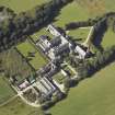 Oblique aerial view centred on the college, church, chapel, dovecot, walled garden and cottage, taken from the E.