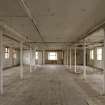 Interior. Old mill building, 3rd floor, view from N. Well lit, slender cast -iron columns. Probably original floor.