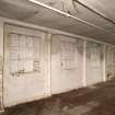Interior. Old mill building, ground floor, view of later blocked windows on W wall. This originally was open  with heavier columns than thhose seeen in DP022425.