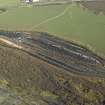 Oblique aerial view centred on railway marshalling yard showing area of former sidings on W side, taken from the SW.