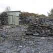 Detail from NE.  Showing modern wooden huts built into slate heaps.