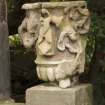 Detail of carved stone urn on wall to NE of main house.