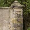 Detail of gate pier to NE of main house showing carved stonework and ball finial from S.