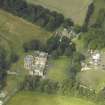Oblique aerial view centred on the country house with the Collegiate Chapel adjacent, taken from the SW.