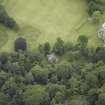 Oblique aerial view centred on the burial vault with the country house adjacent, taken from the NE.