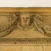 Interior.  Detail of carved wooden head on panelling in Ante-Room.