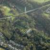 Oblique aerial view centred on the house with the bridge adjacent, taken from the NW.