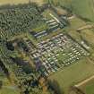 Oblique aerial view centred on the remains of the POW camp, now a caravan park, taken from the SW.
