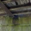 Detail from S of bridge wooden decking, brick abutmnets and cast iron girder supports on underside.